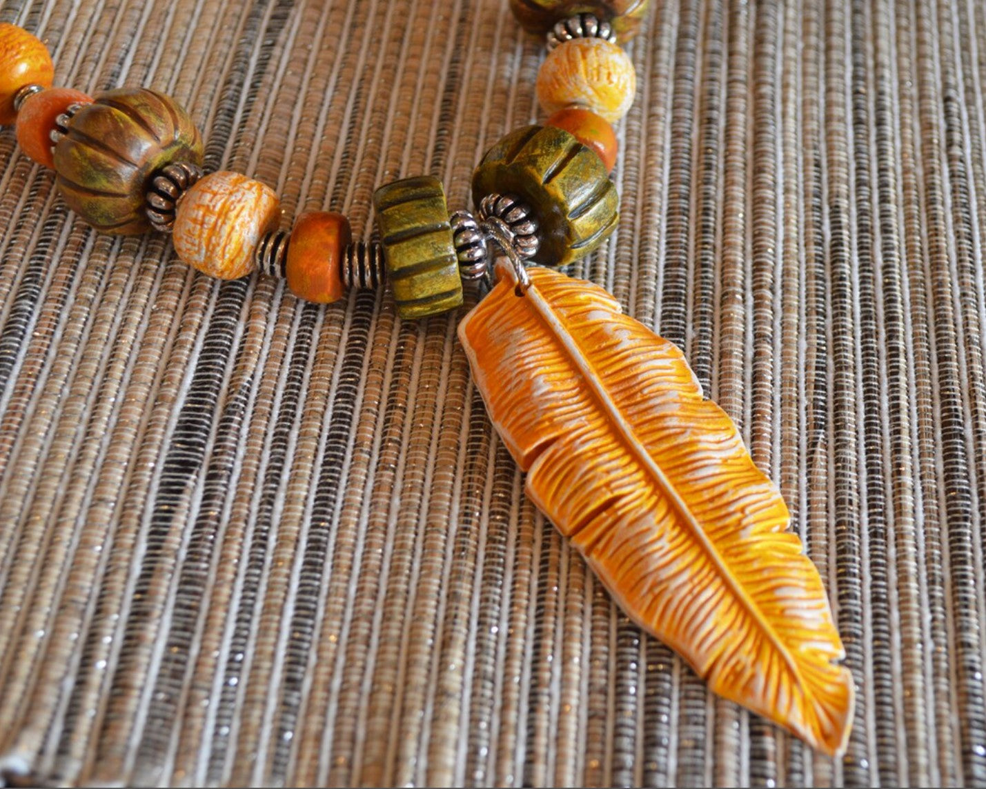 One of a kind statement beads polymer clay pendant necklace / earthy yellow feather