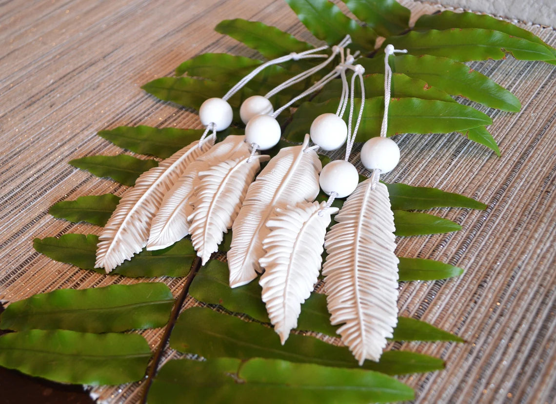 6 white feather shaped ornaments