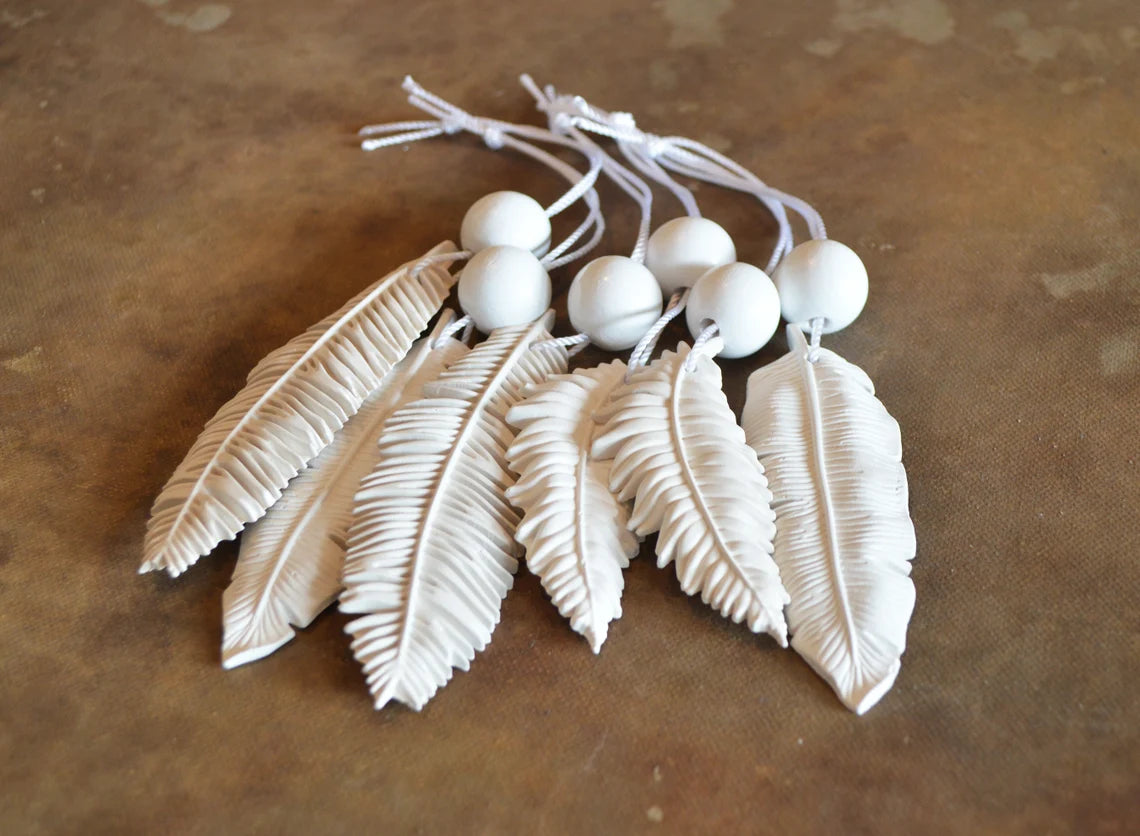 6 white feather shaped ornaments